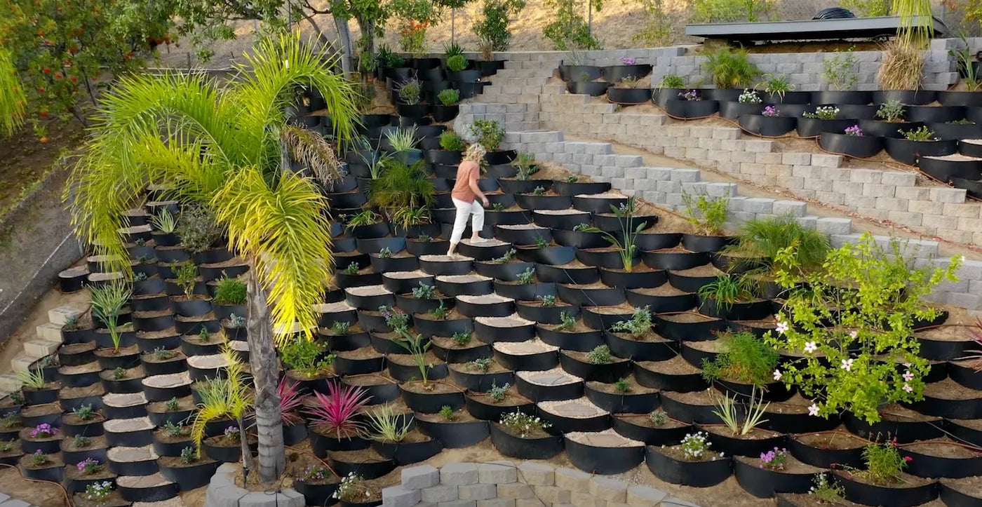 Lady walking up hill with Dirt Locker erosion control